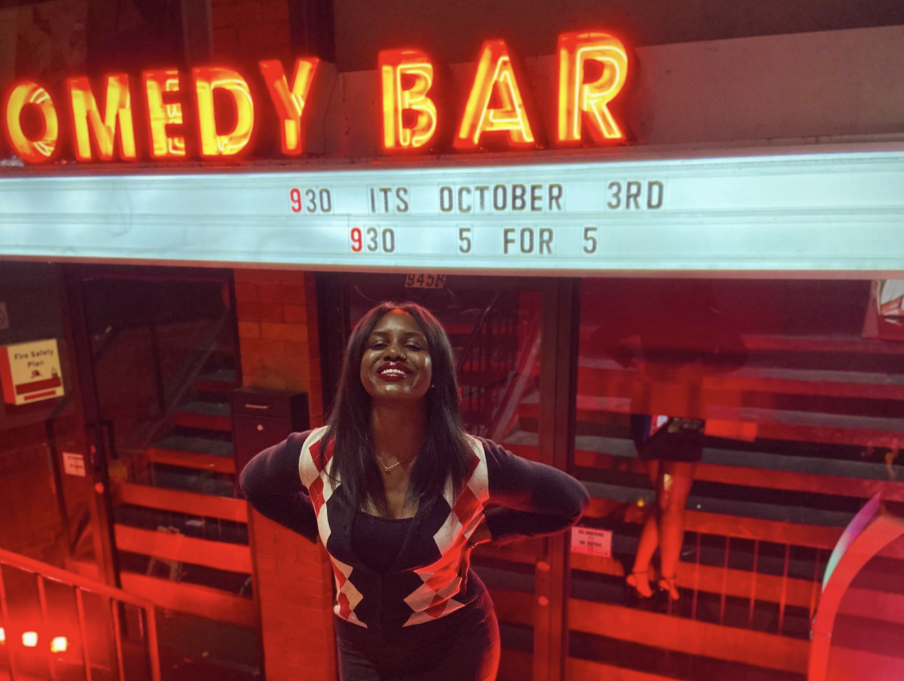 ZILLAH FERGUSON SMILES WHILE STANDING IN FRONT OF COMEDY BAR’S BLOOR STREET LOCATION. 